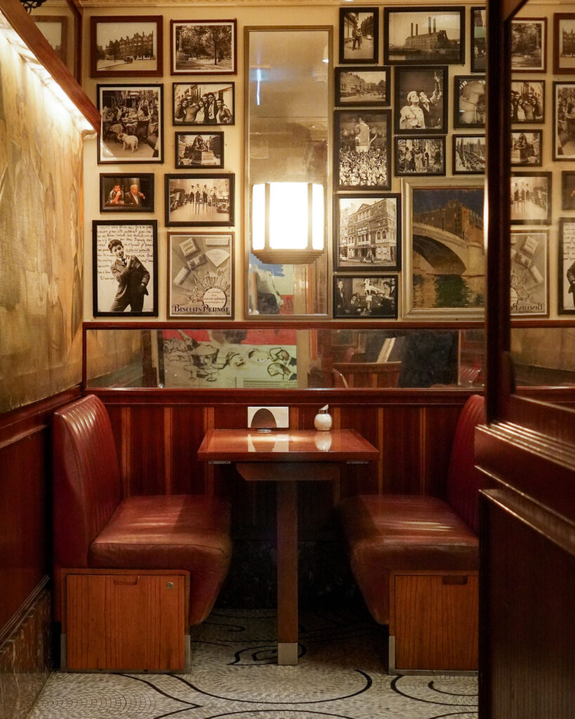 Interior shot of Colbert, with a booth and art on the wall.